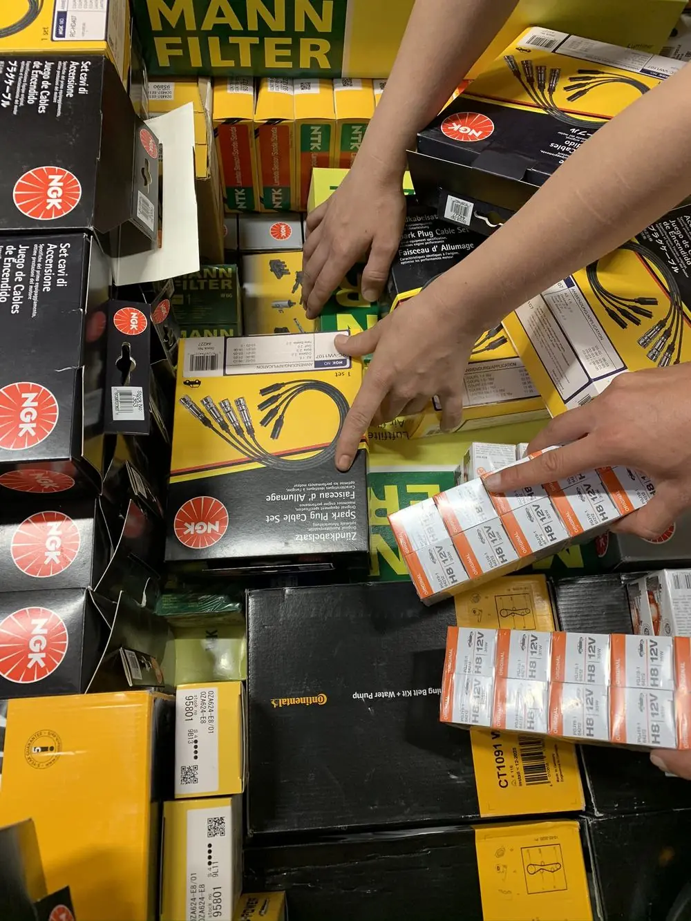 Mixed aftermarket stock being checked by hand